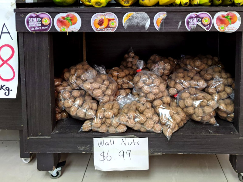 Wall Nuts price tag for walnuts in a green grocer shop.