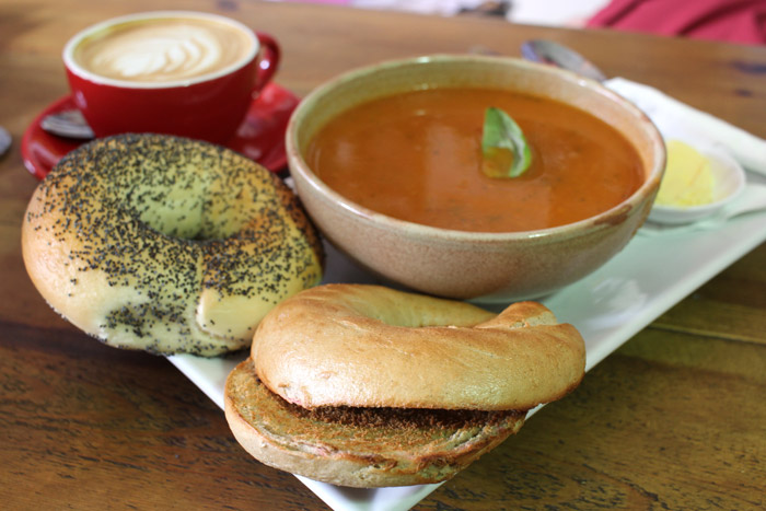 Bagels with tomato soup and a coffee.